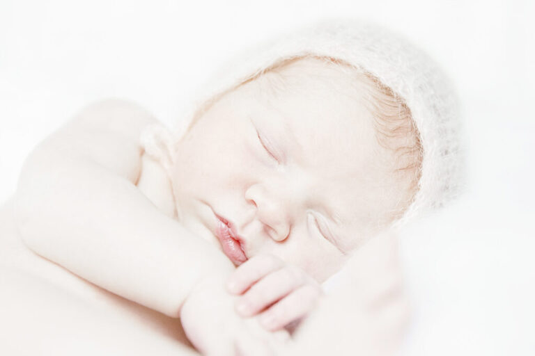 minimal props, bright and airy newborn close up of baby girls photography on white background