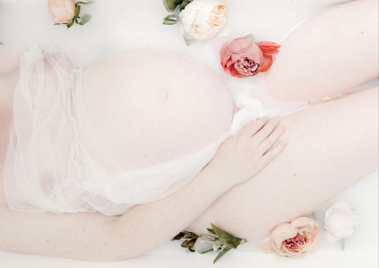 minimal milky bath maternity photoshoot. Seminude maternity photography showing off  a  timeless bump. Photography in Woodford, London by petite feet photography
