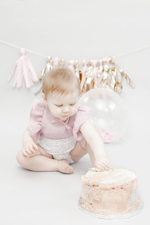 cake smash photographer Epping. Sweet Cake smash baby girl studio photography, pink pastel colours