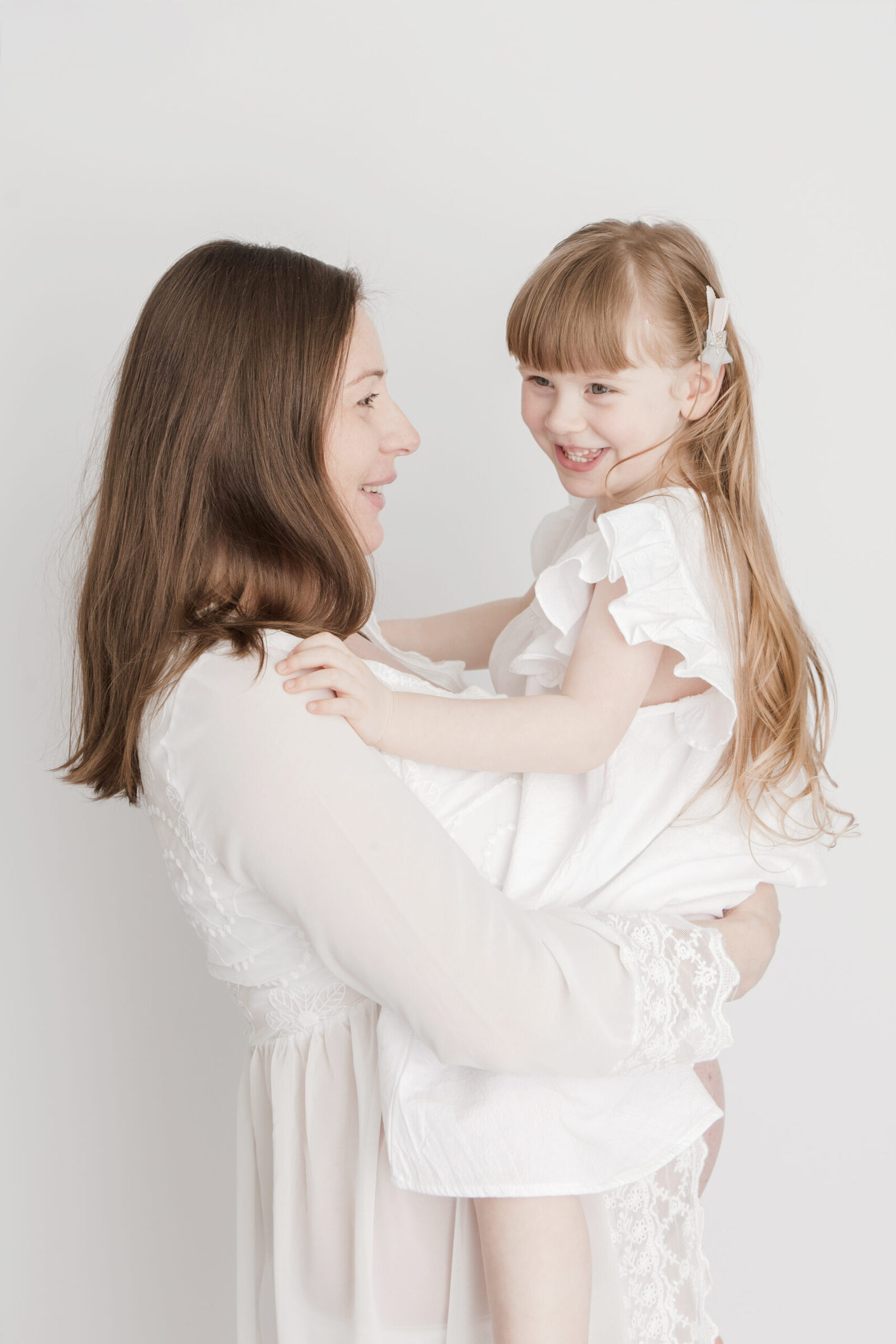 minimal white maternity portrait with toddler in studio East London no props