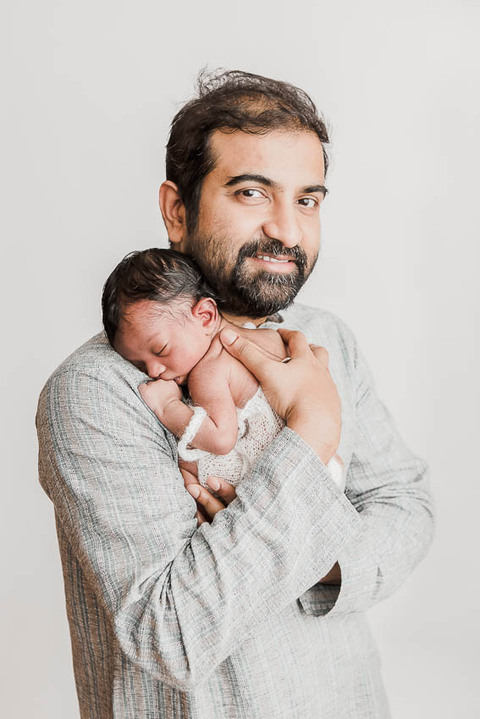 Epping Newborn Photographer. Why I do what I do. Newborn baby boy with his dad photography in home studio set up, no props, white background, minimal and timeless newborn photography, Woodford, London, West Essex by petite feet photography