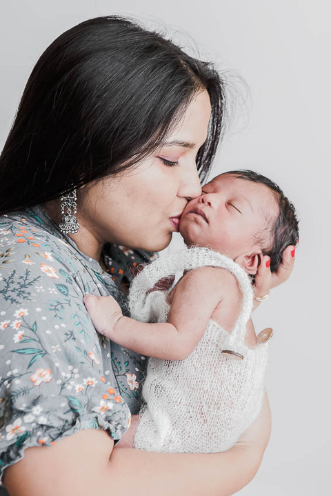 Epping Newborn Photographer. Why I do what I do. Newborn baby boy with his mum photography in home studio set up, no props, white background, minimal and timeless newborn photography, Woodford, London, West Essex by petite feet photography