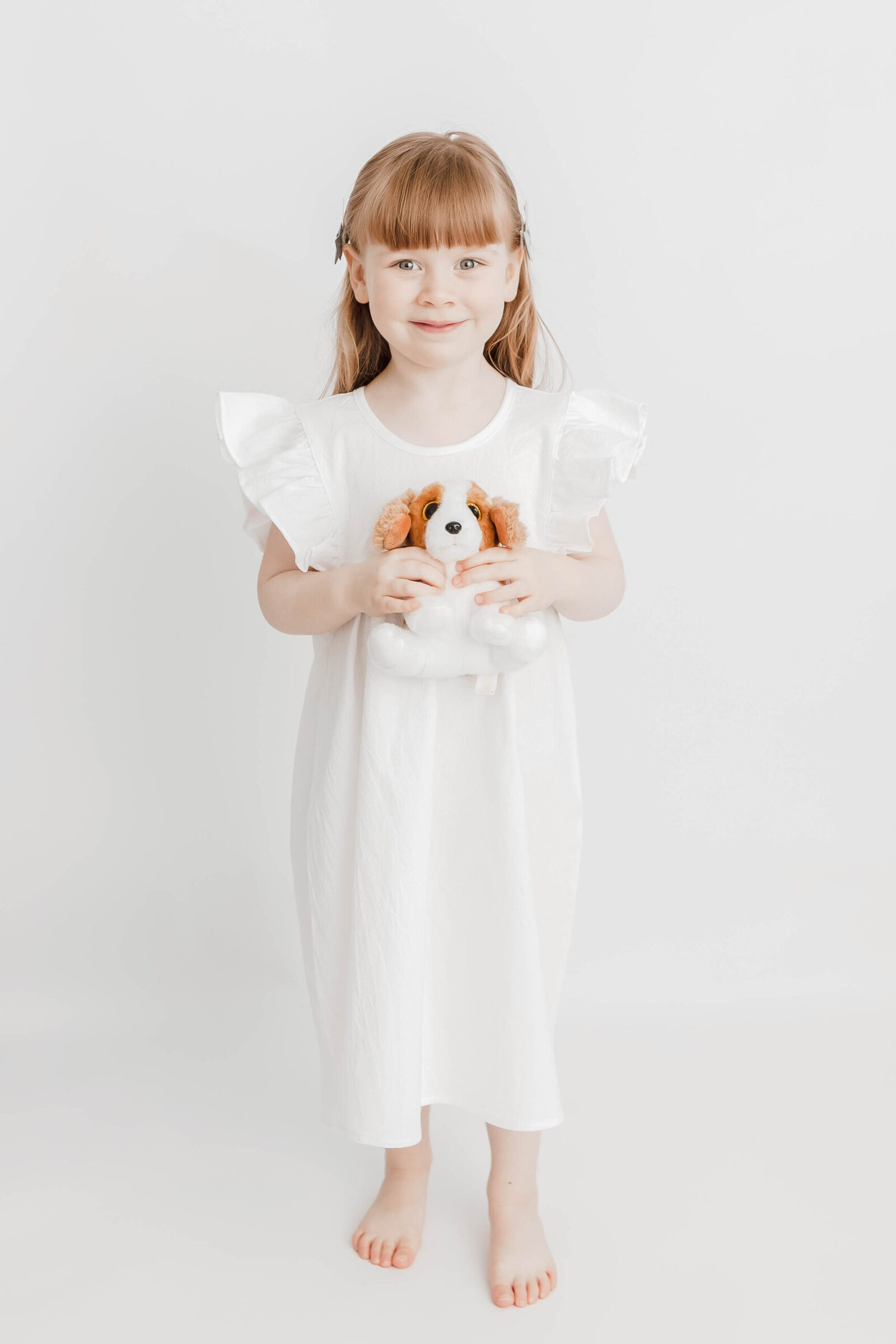 Girl studio portrait with white tree in white background ,minimalistic approach by petite feet photography in London