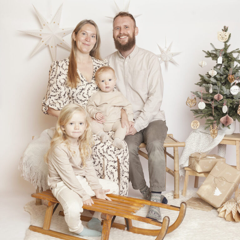 nordic Christmas family portrait in London by petite feet photography, parents and kids set in a white contemporary and timeless studio set up