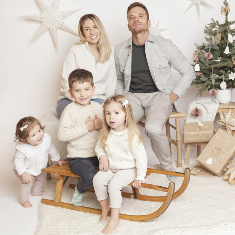 nordic Christmas family portrait in London by petite feet photography, parents and kids set in a white contemporary and timeless studio set up